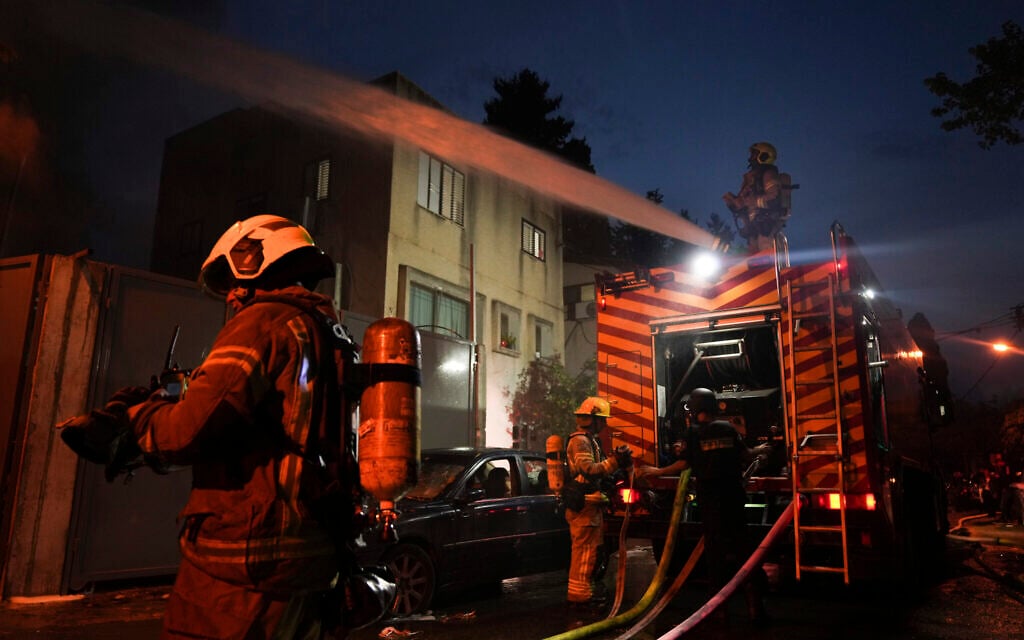 Firefighters work to extinguish a fire after a rocket fired from Lebanon hit Kiryat Atta in northern Israel, November 11, 2024. (AP Photo/Francisco Seco) Firefighters work to extinguish a fire after a rocket fired from Lebanon hit Kiryat Atta in northern Israel, November 11, 2024. (AP Photo/Francisco Seco)