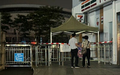 Pople look at barriers set up where a man deliberately rammed his car into people exercising, killing at least 35 and injuring many others, in Zhuhai, in southern China's Guangdong province, November 12, 2024. (AP Photo/Ng Han Guan)