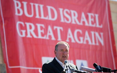 Then-Gov. Mike Huckabee, R-Ark., takes questions from the media, prior to laying a brick at a new housing complex in the West Bank settlement of Efrat, August 1, 2018. (AP Photo/Oded Balilty, File)