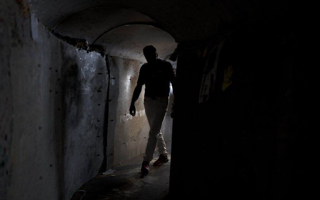 A visitor walks through a replica of a tunnel built by Hamas terrorists in the Gaza Strip, at Hostage Square in Tel Aviv, November 14, 2024. (AP Photo/Maya Alleruzzo)