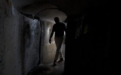 A visitor walks through a replica of a tunnel built by Hamas terrorists in the Gaza Strip, at Hostage Square in Tel Aviv, November 14, 2024. (AP Photo/Maya Alleruzzo)