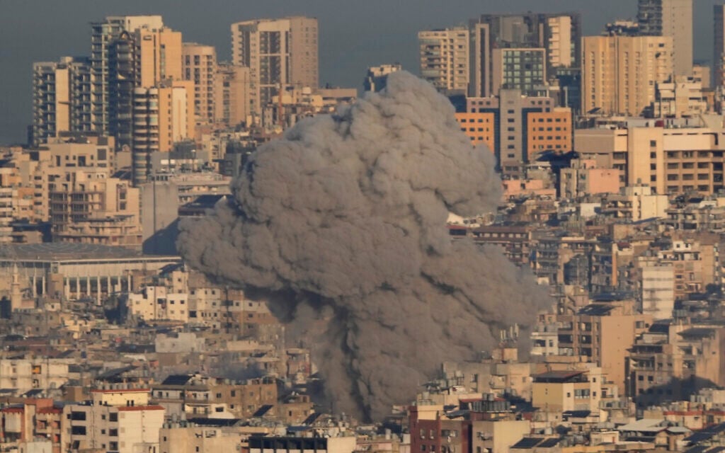 Smoke rises between buildings after an Israeli airstrike in Dahiyeh, in the southern suburbs of Beirut, Lebanon, November 15, 2024. (AP Photo/Hussein Malla)