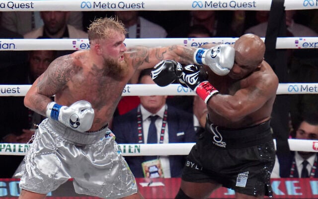 Jake Paul, left, lands a left on Mike Tyson during their heavyweight boxing match, in Arlington, Texas November 15, 2024. (Julio Cortez/AP) Jake Paul, left, lands a left on Mike Tyson during their heavyweight boxing match, in Arlington, Texas November 15, 2024. (Julio Cortez/AP)