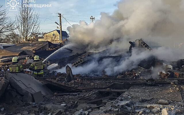 In this photo provided by the Ukrainian Emergency Service, emergency services personnel work to extinguish a fire following a Russian rocket attack in Lviv, Ukraine, Nov. 17, 2024. (Ukrainian Emergency Service via AP)
