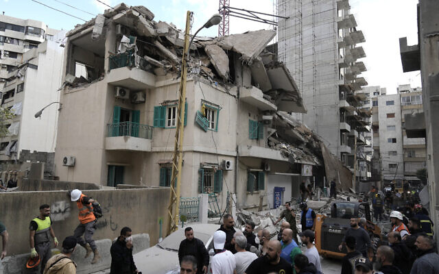 Residents and rescuers gather at the site of an Israeli airstrike that hit a building in central Beirut's Ras el-Nabaa neighborhood, Lebanon, November 17, 2024. (AP Photo/Bilal Hussein) Residents and rescuers gather at the site of an Israeli airstrike that hit a building in central Beirut's Ras el-Nabaa neighborhood, Lebanon, November 17, 2024. (AP Photo/Bilal Hussein)