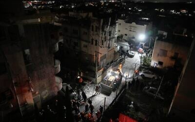 Medics and police at the scene of a deadly Hezbollah rocket impact in Shfar'am, northern Israel, November 18, 2024. (AP Photo/Leo Correa)