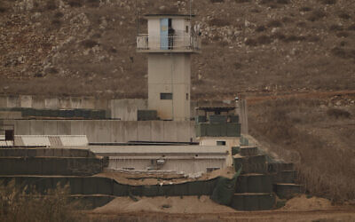 An UN soldier stands on the top of a tower at a base of the United Nations peacekeeping forces in Lebanon (UNIFIL) at the Israeli-Lebanese border as seen from northern Israel, November 19, 2024. (Leo Correa/AP)