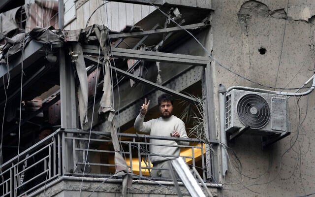 A man flashes a victory sign from his damaged apartment following Israeli strikes in Dahiyeh, a Hezbollah stronghold in  in the southern suburb of Beirut, Lebanon, November 25, 2024. (AP Photo/Hussein Malla)