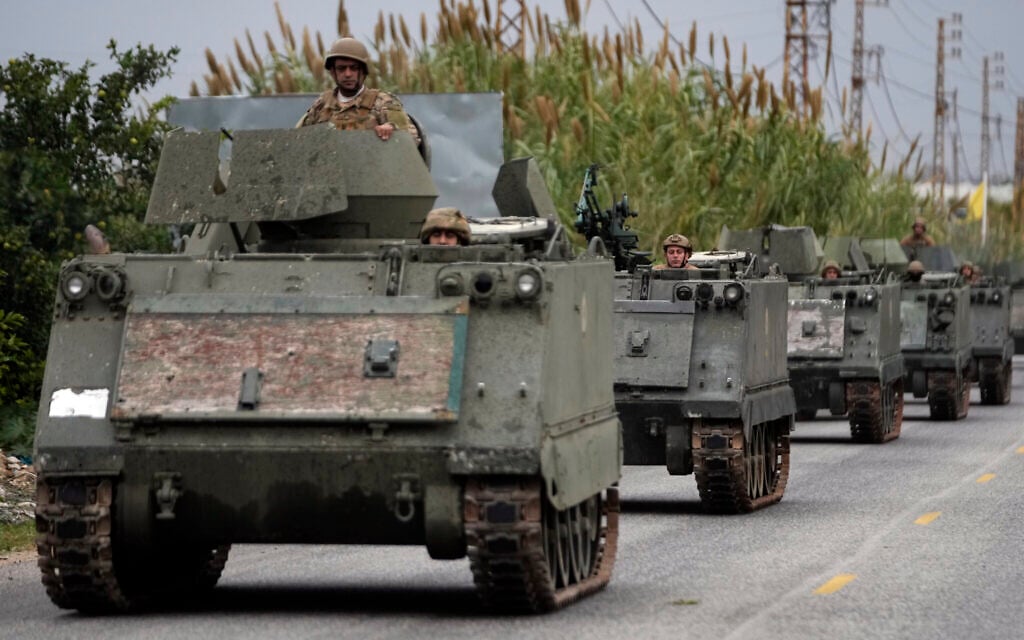 Lebanese soldiers ride in a convoy in Mansouri, as they head to southern Lebanon, following a ceasefire between Israel and Hezbollah that went into effect on Wednesday, Nov. 27, 2024. (AP/Hussein Malla)