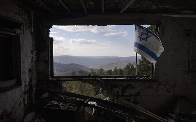 A Lebanese village is seen through a window of a damaged house that was hit by a rocket fired from Lebanon, in Kibbutz Manara in northern Israel, November 28, 2024. (AP Photo/Leo Correa)