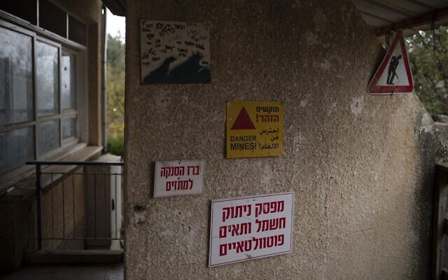 A sign warning of mines hangs on the wall of a residence for teenagers at Kibbutz Malkiya in northern Israel, November 27, 2024. (AP Photo/Leo Correa)