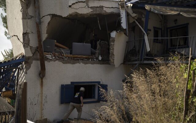 Orna Weinberg checks the damaged home of a family friend after it was damaged by a rocket fired from Lebanon, in Kibbutz Manara in northern Israel, November 28, 2024. (AP Photo/Leo Correa)