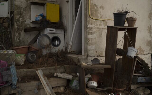 A washing machine stands outside a damaged house in Kibbutz Manara in northern Israel, November 28, 2024. (AP Photo/Leo Correa)