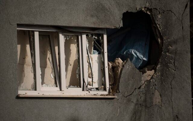A hole next to a window shows the impact of a rocket fired from Lebanon, on a house in Kibbutz Manara in northern Israel, November 28, 2024. (AP Photo/Leo Correa)