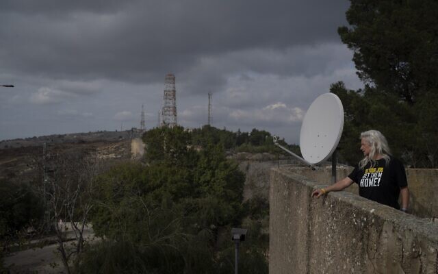 Orna Weinberg looks toward the Israeli-Lebanese border as she stands on a building in Kibbutz Manara in northern Israel, November 28, 2024. (AP Photo/Leo Correa)