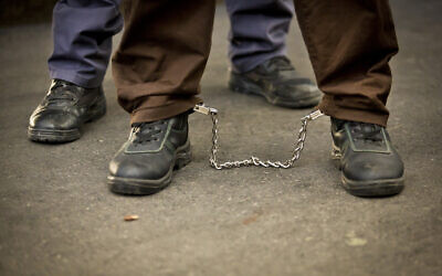 Illustrative: A security prisoner in chains. July 29, 2013. (Moshe Shai/FLASH90)