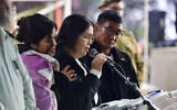 Enrico (right) and Imelda (center) speak at the funeral of their son, Cedrick Garin, who was killed in Gaza, at Kiryat Shaul Military Cemetery, on January 25, 2024. (Avshalom Sassoni/ Flash90)