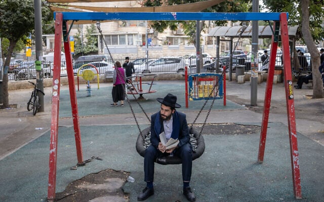 A member of the Haredi community near a protest against the drafting of ultra-Orthodox Jews outside an IDF recruitment center in Jerusalem, October 31, 2024. (Chaim Goldberg/Flash90)