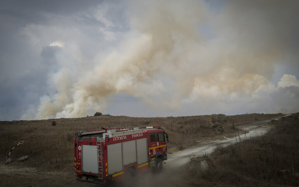 Firefighters work to battle blazes sparked by a rocket barrage fired by Hezbollah from Lebanon at the Golan Heights, November 3, 2024. (Michael Giladi/ Flash90)