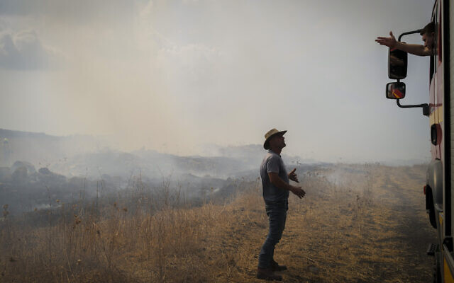Firefighters control wildfires after a massive 25-missile attack on the northern town of Katzrin and central Golan Heights, on November 3, 2024. (Michael Giladi/Flash90) Firefighters control wildfires after a massive 25-missile attack on the northern town of Katzrin and central Golan Heights, on November 3, 2024. (Michael Giladi/Flash90)