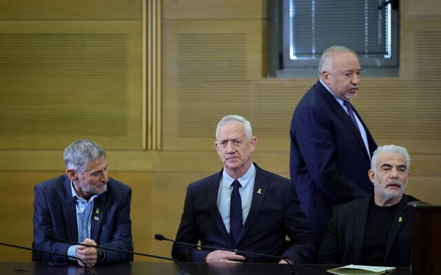 (L-R) The Democrats party head Yair Golan, National Unity party head Benny Gantz, Yisrael Beytenu party Avigdor Liberman (standing) and Yesh Atid party head and Opposition Leader Yair Lapid hold a joint press conference at the Knesset in Jerusalem on November 6, 2024. (Yonatan Sindel/Flash90)