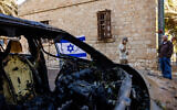 Damage caused to vehicles and buildings from a missile fired from Lebanon on November 16, 2024, in the northern Israeli city of Haifa, photographed on November 17, 2024. (Yonatan Sindel/Flash90)