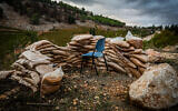 A chair is surrounded by protective sandbags in Metula, on the Israeli side of the border with Lebanon, November 20, 2024. (David Cohen/Flash90)