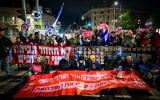 Protesters block a road in demand for a hostage-ceasefire deal, in Jerusalem, November 27, 2024. (Chaim Goldberg/Flash90)