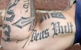 Part of a tattoo reading 'Yeshua,' Jesus' name in Hebrew, and another reading 'Deus Vult' can be seen on the arm of Pete Hegseth in a video he posted to Instagram in May 2020. (Instagram video screenshot: used in accordance with Clause 27a of the Copyright Law)