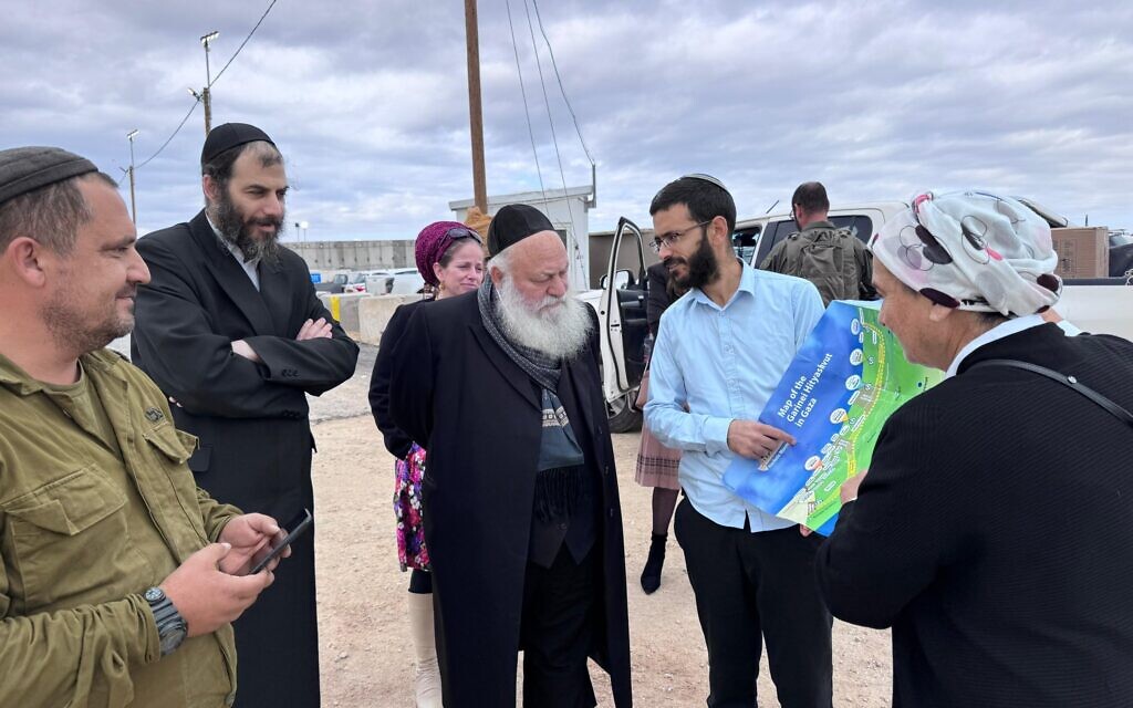 UTJ's Yitzhak Goldknopf, center, pictured with a map of prospective settlements in Gaza during a tour of the Gaza border area, November 28, 2024. Daniella Weiss is seen on the right. (Courtesy Yitzhak Goldknopf)