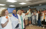 Staff at Tel Aviv's Ichilov Hospital bid farewell to Nova survivor Nati Ganon (second left), who was hospitalized after being seriously wounded during Hamas's October 7, 2023, massacre and discharged on November 4, 2024. (Jenny Yerushalmi/Ichilov spokesperson)