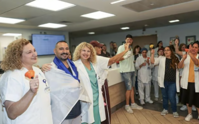 Staff at Tel Aviv's Ichilov Hospital bid farewell to Nova survivor Nati Ganon (second left), who was hospitalized after being seriously wounded during Hamas's October 7, 2023, massacre and discharged on November 4, 2024. (Jenny Yerushalmi/Ichilov spokesperson) Staff at Tel Aviv's Ichilov Hospital bid farewell to Nova survivor Nati Ganon (second left), who was hospitalized after being seriously wounded during Hamas's October 7, 2023, massacre and discharged on November 4, 2024. (Jenny Yerushalmi/Ichilov spokesperson)