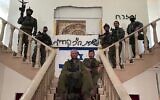 Otzma Yehudit MK Yitzhak Kroizer (center) with fellow soldiers in a house in southern Lebanon on November 1, 2024. The Hebrew graffiti reads: "Office of MK Kroizer." (Courtesy)