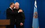 Incoming Defense Minister Israel Katz (L) embraces Yoav Gallant at a handover ceremony in the Defense Ministry after Gallant was fired from the post, November 8, 2024. (Ariel Hermoni/Defense Ministry)
