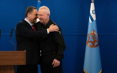 Incoming Defense Minister Israel Katz (L) embraces Yoav Gallant at a handover ceremony in the Defense Ministry after Gallant was fired from the post, November 8, 2024. (Ariel Hermoni/Defense Ministry) Incoming Defense Minister Israel Katz (L) embraces Yoav Gallant at a handover ceremony in the Defense Ministry after Gallant was fired from the post, November 8, 2024. (Ariel Hermoni/Defense Ministry)