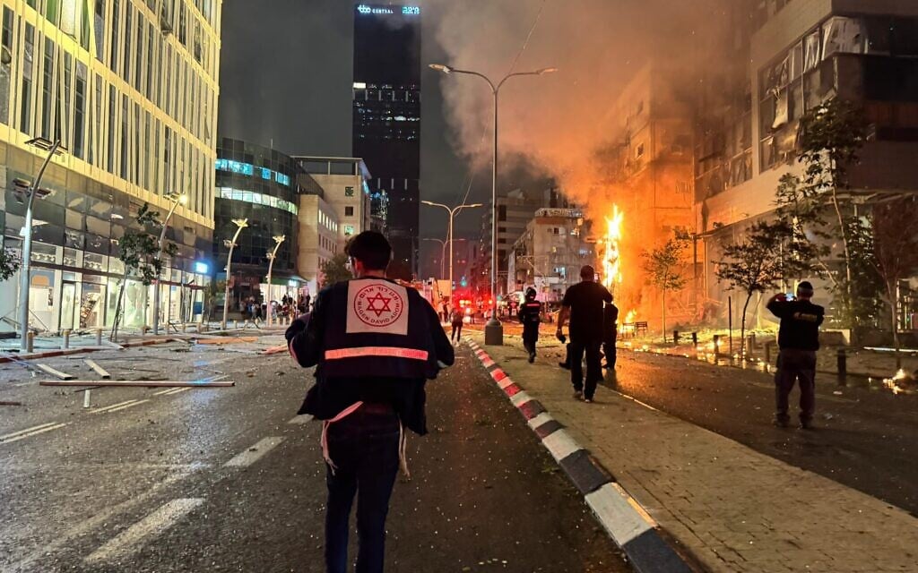 Medics at the scene of an impact of rocket fragments between Ramat Gan and Bnei Brak in central Israel, November 18, 2024. (Magen David Adom)