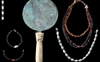 Assembly of finds from a new discovery of 11 sealed Middle Kingdom burials in Luxor. Here, shown from Burial 2: a copper or copper alloy mirror with an ivory handle displaying the rather rare design of a four-faced Hathor presenting her as a woman with austere features. (South Asasif Conservation Project)