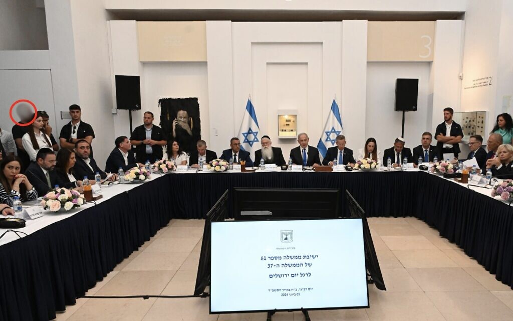 Prime Minister Benjamin Netanyahu, surrounded by ministers, leads a cabinet meeting at the Bible Lands Museum to mark Jerusalem Day, June 5, 2024. The alleged suspect in a security leak is blurred and circled to the left of the image (Haim Zach/GPO)