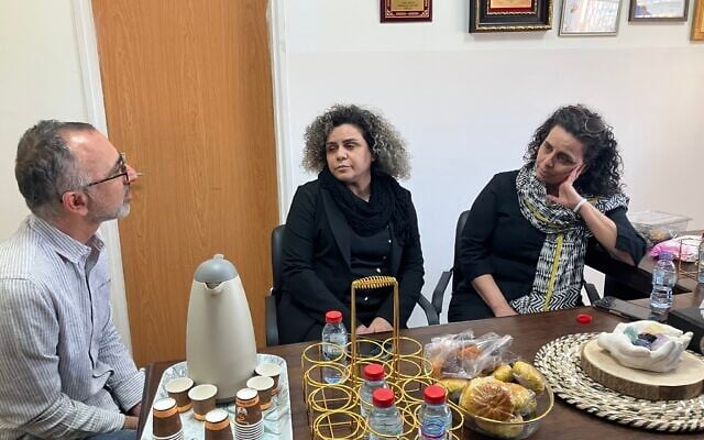 Tag Meir member Yossi Saidov, left, apologizes to Hanaa Younis, center, and Najlaa Awad, right, for the racist comments on social media about their sister Safaa Awad, killed by November 18 Hezbollah rocket fire on November 21, 2024. (Diana Bletter/Times of Israel)