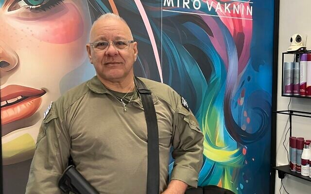 Miro Vahknin, a member of the first response team of Rosh Hanikra, in his hair salon in Nahariya on November 26, 2024. (Diana Bletter/Times of Israel)