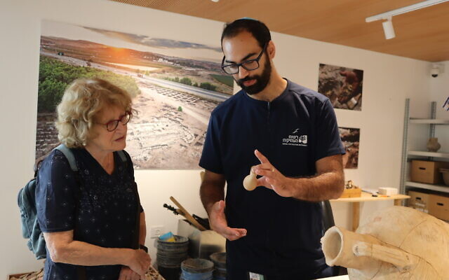A visitor at the hands-on exhibit at the National Campus for the Archeology of Israel in Jerusalem with museum guide Yehuda Maimoun. (Shmuel Bar-Am)