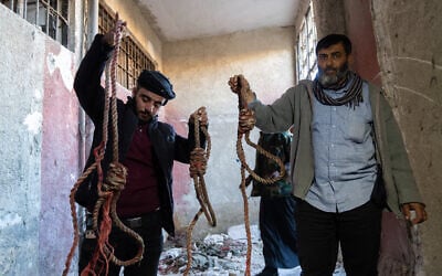 People are seen at the Sednaya Military Prison after armed groups take control in Damascus, Syria on December 9, 2024. (Emin Sansar / Anadolu / Reuters)