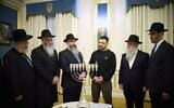 Illustrative: Ukrainian President Volodymyr Zelensky (third right) lights Hanukkah candles with rabbis in Kyiv on December 25, 2024. (UKRAINIAN PRESIDENTIAL PRESS SERVICE)