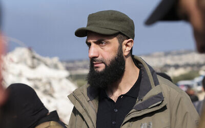 Hayat Tahrir al-Sham (HTS) group's chief Abu Mohammed al-Julani checks the damage following an earthquake in the village of Besnaya in Syria's rebel-held northwestern Idlib province at the border with Turkey, on February 7, 2023. (Omar HAJ KADOUR / AFP)