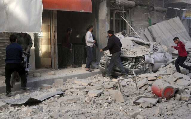 People check the damage at the scene of a pro-regime forces strike that targeted a neighborhood in Syria's rebel-held northern city of Idlib on December 1, 2024 (MUHAMMAD HAJ KADOUR / AFP) People check the damage at the scene of a pro-regime forces strike that targeted a neighborhood in Syria's rebel-held northern city of Idlib on December 1, 2024 (MUHAMMAD HAJ KADOUR / AFP)