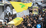 A mourner carries a portrait of slain Hezbollah's chief Hassan Nasrallah during the funeral procession of Hezbollah fighters, killed during the war with Israel, in Beirut's southern suburbs, on December 4, 2024. (AFP)