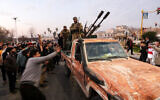 Residents take to the streets of Hama, to welcome anti government fighters after they took control of Syria's west-central city on December 5, 2024. (Photo by Bakr Alkasem / AFP)