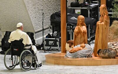 Pope Francis prays before the 'Nativity of Bethlehem 2024,' upon its inauguration in the Paul VI Hall, during the private audience with donors of the nativity scene and the lighting of the Christmas tree ceremony at St Peter's Square, in the Paul-VI hall at the Vatican on December 7, 2024. (Andreas Solaro/ AFP)