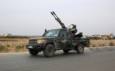 Anti-government forces drive in Syria's west-central province of Homs on December 7, 2024, on their way to the city of Homs. (Aref TAMMAWI / AFP)