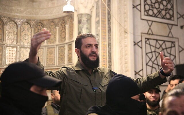 The leader of Syria's Islamist Hayat Tahrir al-Sham (HTS) group that headed a lightning rebel offensive snatching Damascus from government control, Abu Mohammed al-Julani, address a crowd at the capital's landmark Umayyad Mosque on December 8, 2024. (Aref TAMMAWI / AFP)